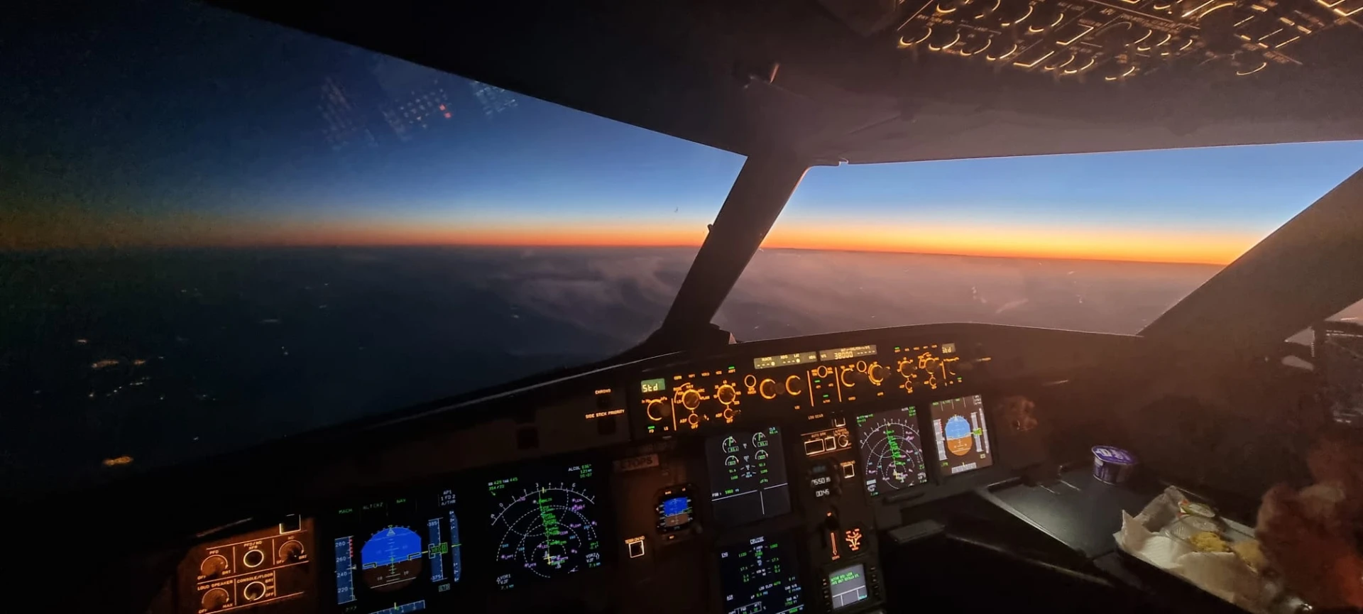 Sunset over the clouds from the cockpit