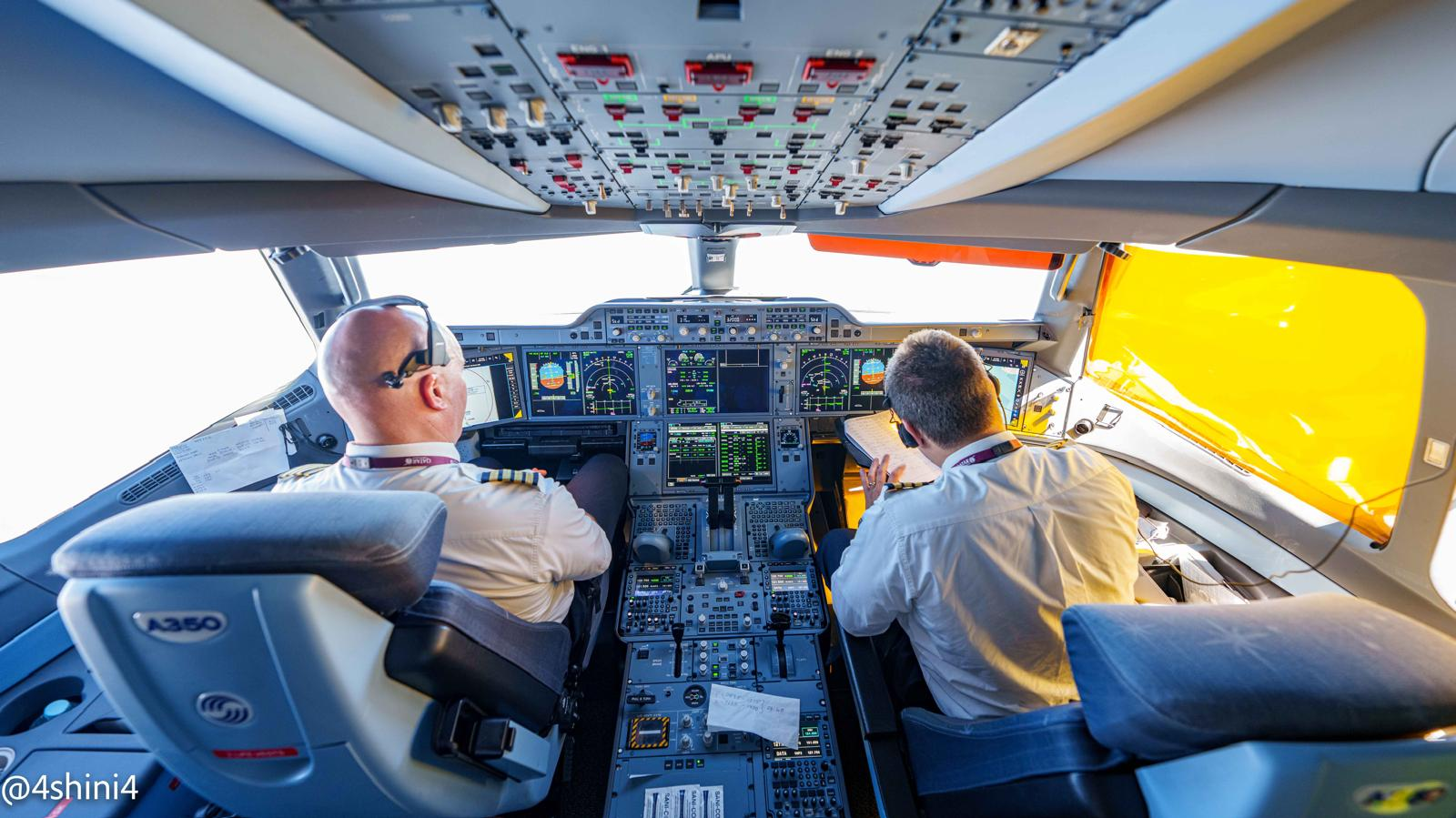 Two pilots at the controls of an Airbus flight deck